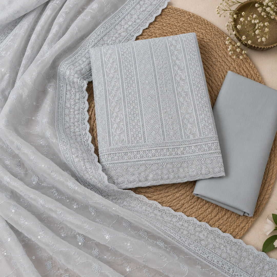 Premium icy grey Chikankari suit fabric with embellished neck design and festive ethnic wear styling