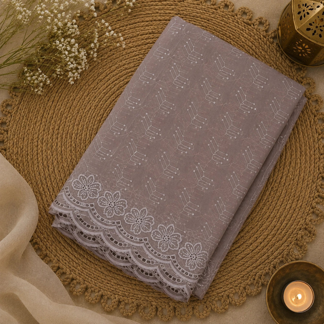Muted lilac floral Schiffli suit fabric featuring delicate beadwork, golden accents and sophisticated ethnic styling