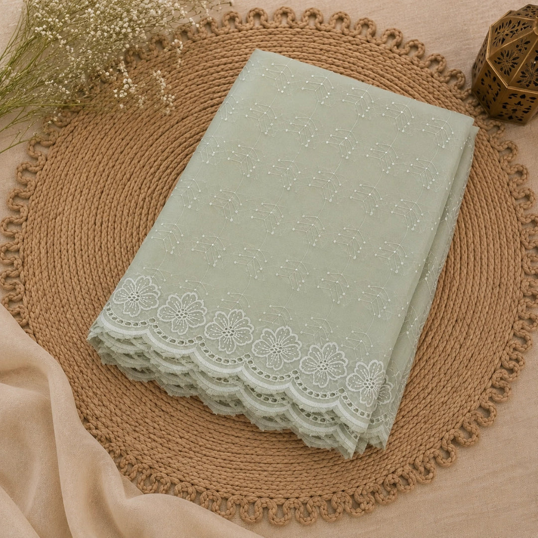 Mint green floral Schiffli suit fabric with intricate beadwork, sequin detailing and elegant ethnic wear styling