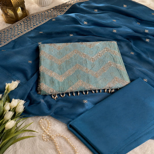 embroidered suit fabric with chevron-inspired design, metallic embellishments and premium ethnic wear styling