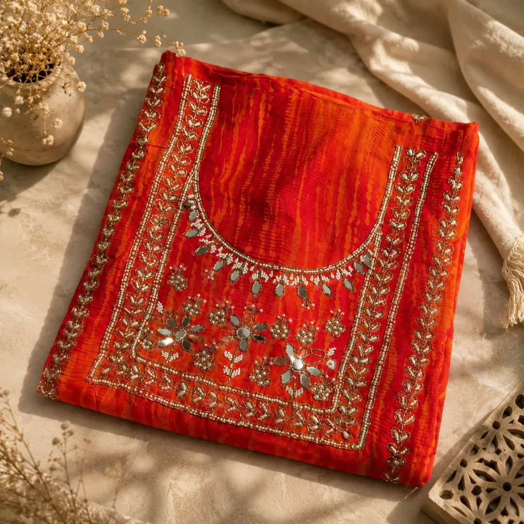 Orange festive suit set featuring floral embroidery, reflective embellishments and sheer designer dupatta with embellished motifs.