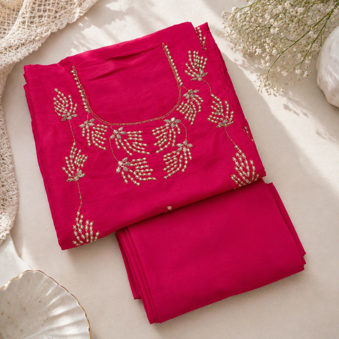 Premium fuchsia pink embroidered suit fabric with embellished detailing and parrot green organza dupatta for festive wear