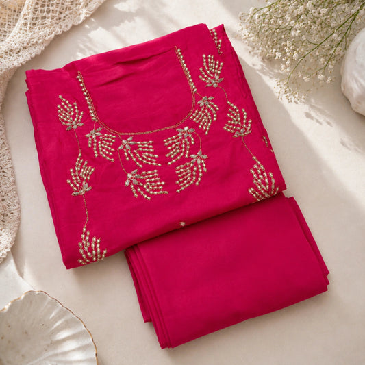 Premium fuchsia pink embroidered suit fabric with embellished detailing and parrot green organza dupatta for festive wear