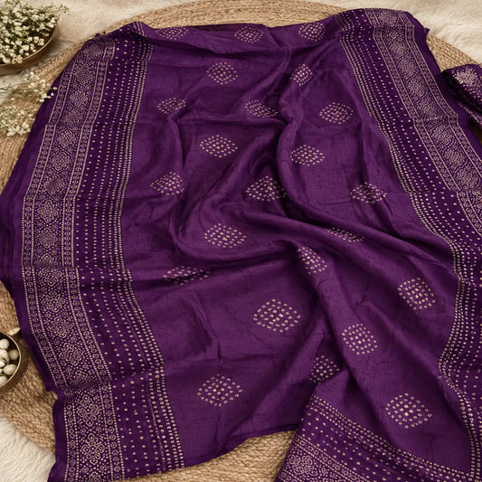 Royal purple unstitched suit set featuring Bandhani-inspired motifs, mirror embellishments and elegant dupatta with golden borders