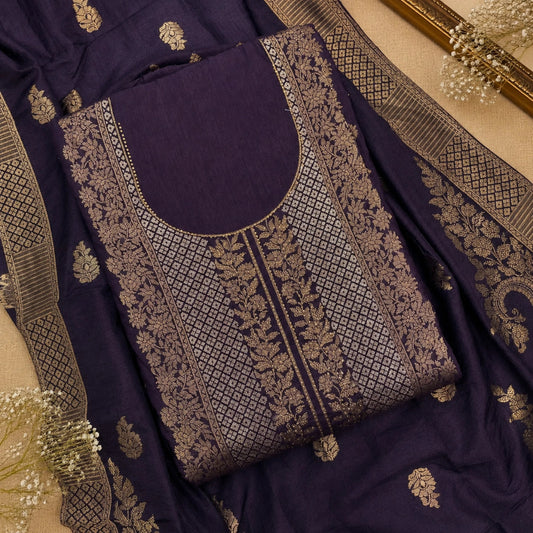 Royal deep plum brocade suit set with intricate zari work, floral motifs and premium unstitched ethnic wear fabric for women