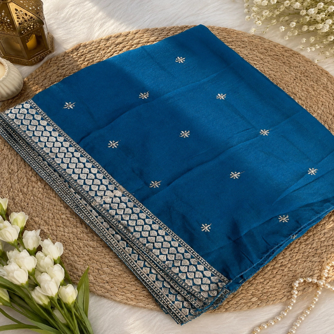 Aqua teal unstitched suit set featuring metallic embroidery, floral border detailing and elegant teal dupatta with decorative border