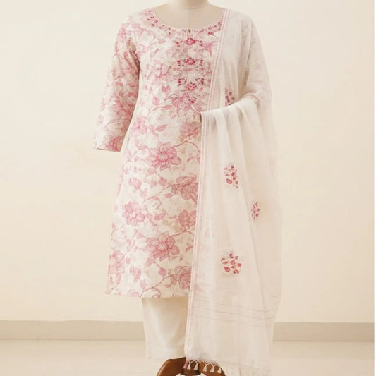 A traditional Indian three-piece salwar kameez suit displayed on a wooden mannequin. The set features a white kurta with pink floral embroidery, white trousers, and a matching white dupatta with pink floral motifs.