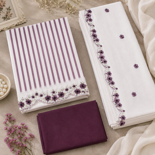 Three folded pieces of white fabric with purple floral and striped patterns, arranged on a beige textured background with dried flowers.